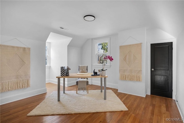 home office with hardwood / wood-style floors and vaulted ceiling