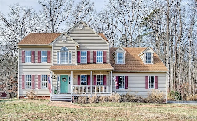 view of front facade with a porch and a front lawn