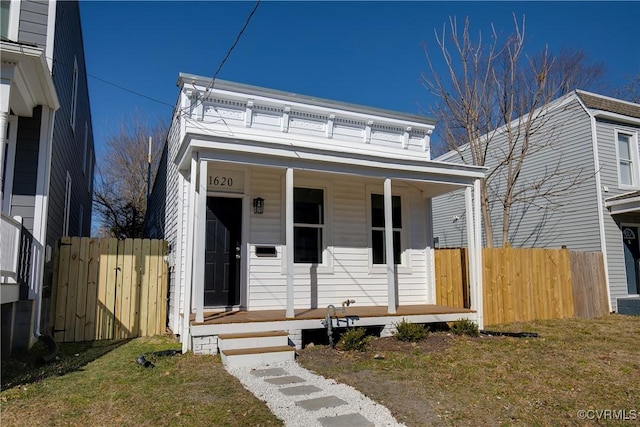 view of front of house featuring covered porch and fence