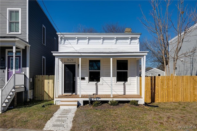 view of front facade with a porch and fence