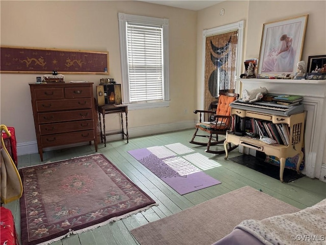 sitting room featuring baseboards and hardwood / wood-style flooring