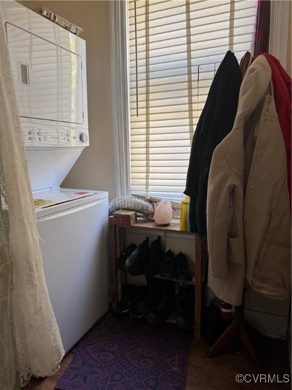 laundry room featuring stacked washer / dryer and laundry area