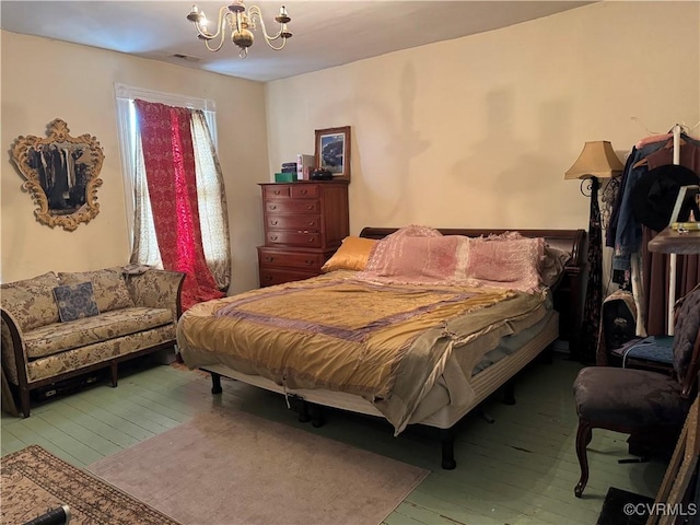 bedroom with a chandelier, visible vents, and hardwood / wood-style floors