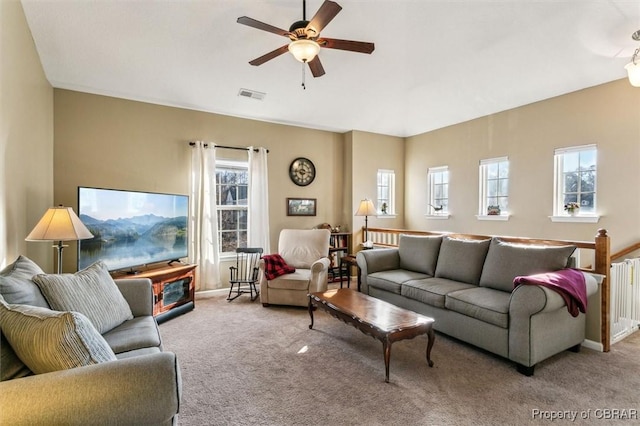 living room featuring light carpet and ceiling fan