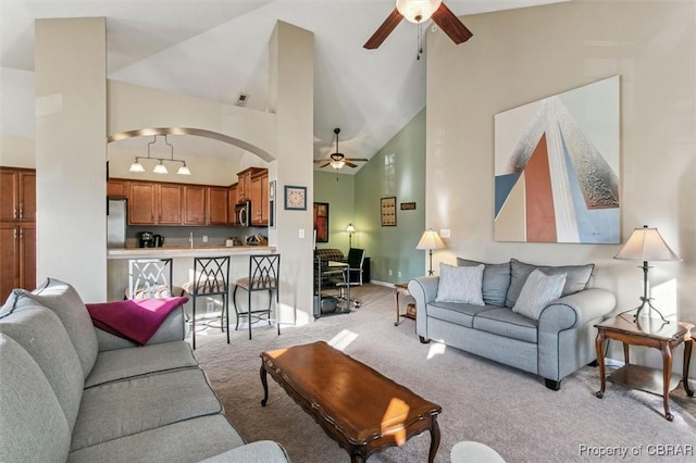 living room with ceiling fan, light carpet, and high vaulted ceiling