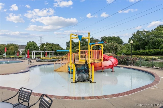 view of play area featuring a community pool and a pergola