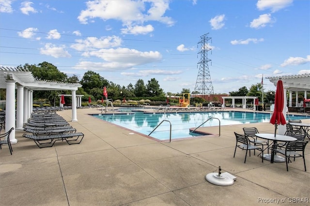 view of swimming pool with a patio area and a pergola