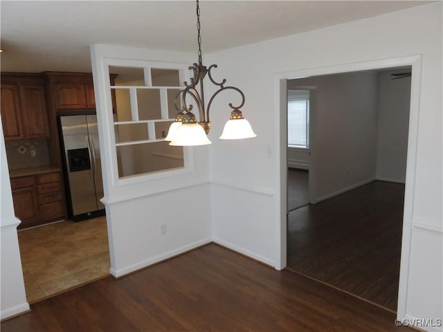 unfurnished dining area featuring dark hardwood / wood-style flooring and a baseboard radiator