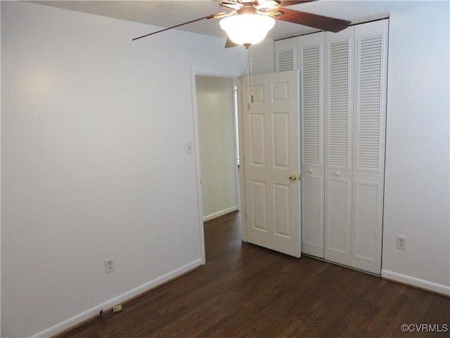 unfurnished bedroom featuring ceiling fan, dark hardwood / wood-style floors, and a closet