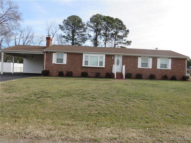 ranch-style house featuring a front lawn and a carport