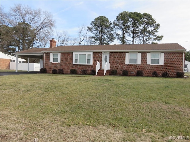 ranch-style home featuring a front lawn and a carport