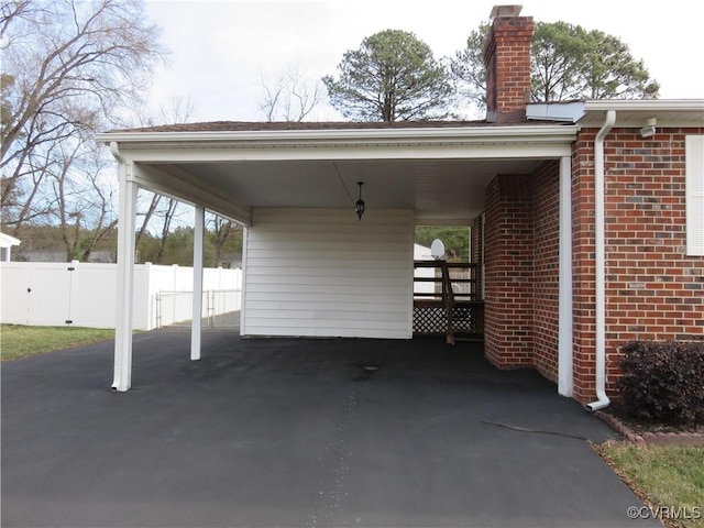 view of vehicle parking with a carport