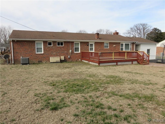 rear view of property with a wooden deck, a yard, and central AC unit