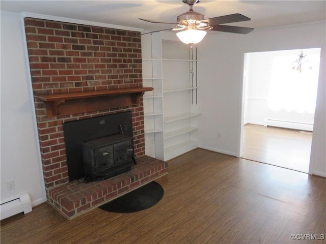 unfurnished living room featuring hardwood / wood-style flooring, a baseboard radiator, and a wood stove