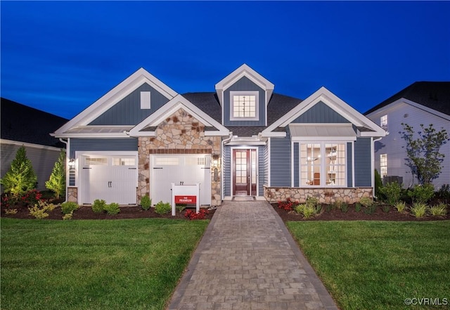 craftsman-style house featuring a garage and a front yard