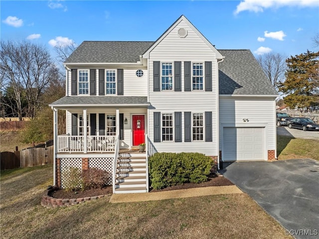 view of front facade featuring a garage, a front lawn, and a porch