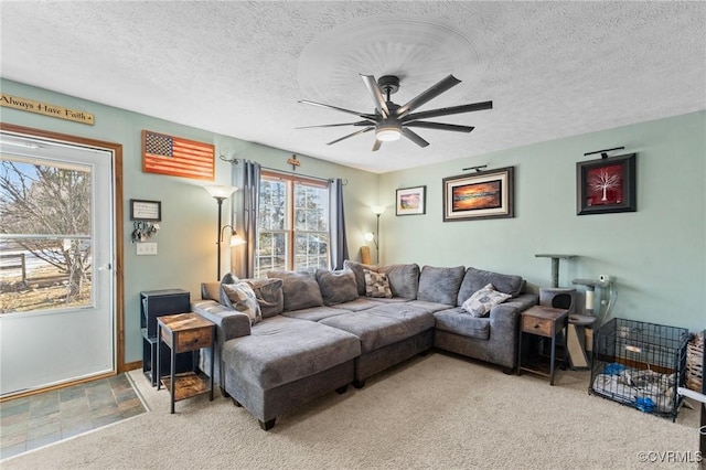 living room with carpet flooring, a textured ceiling, and ceiling fan