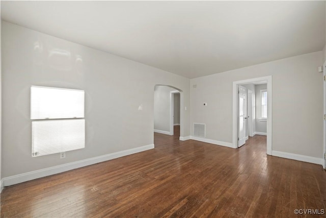 spare room featuring dark wood-type flooring