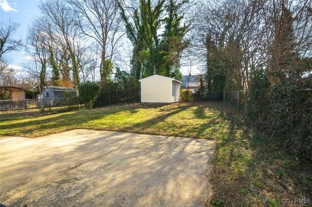 view of yard with a shed and a patio