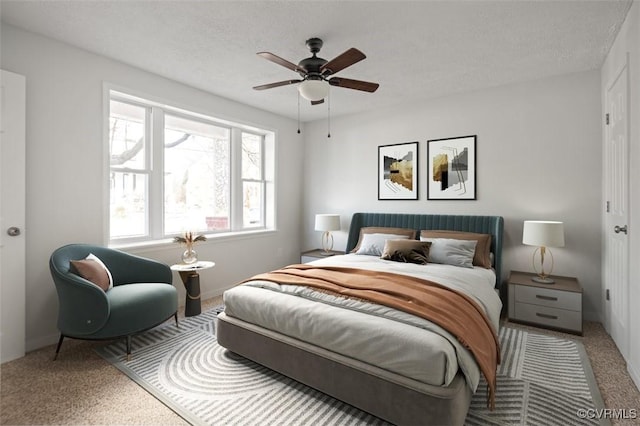 bedroom with ceiling fan, a textured ceiling, and carpet