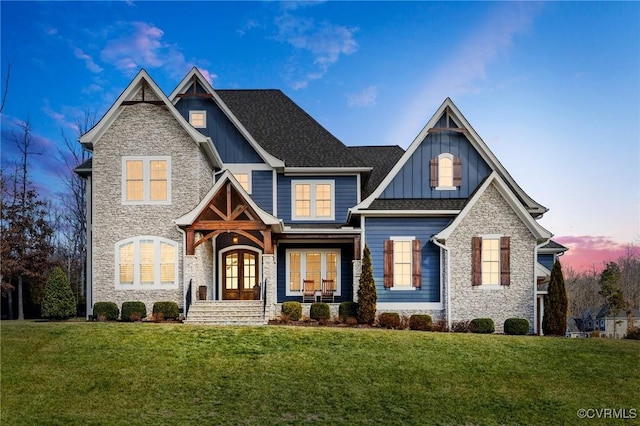 view of front facade featuring french doors, a porch, and a lawn