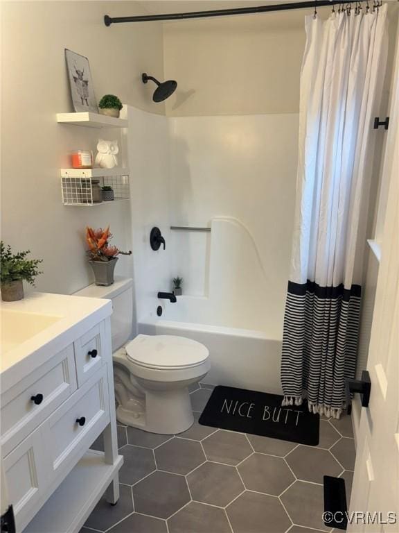 full bathroom with shower / tub combo with curtain, vanity, toilet, and tile patterned flooring