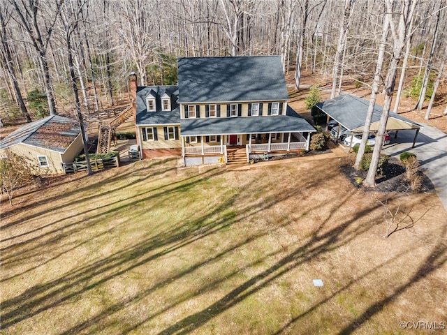 view of front of home with covered porch and a front lawn