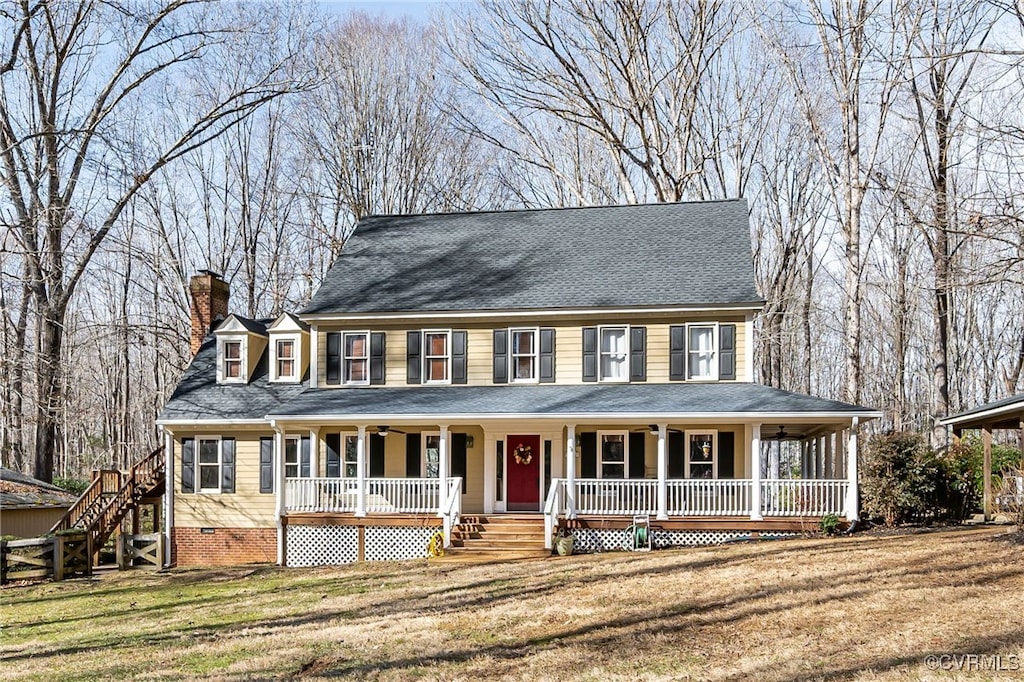 view of front facade with covered porch and a front lawn