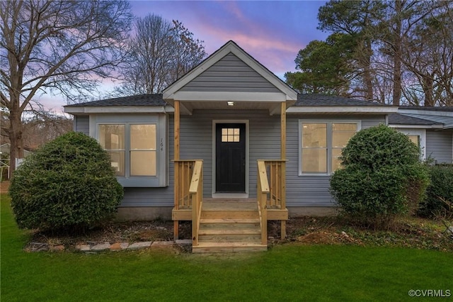 bungalow-style house featuring a yard