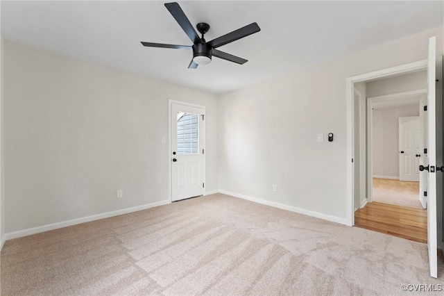 unfurnished room featuring ceiling fan and light carpet