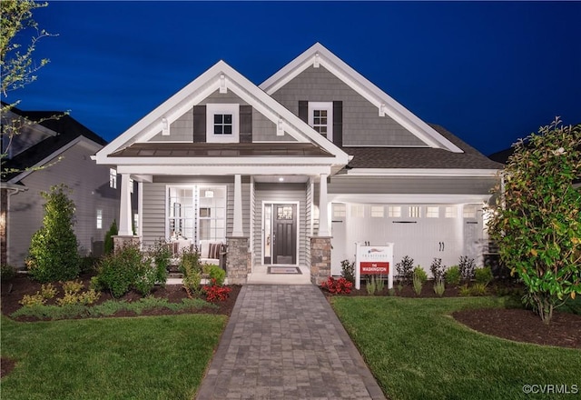 craftsman-style house with a garage and a yard