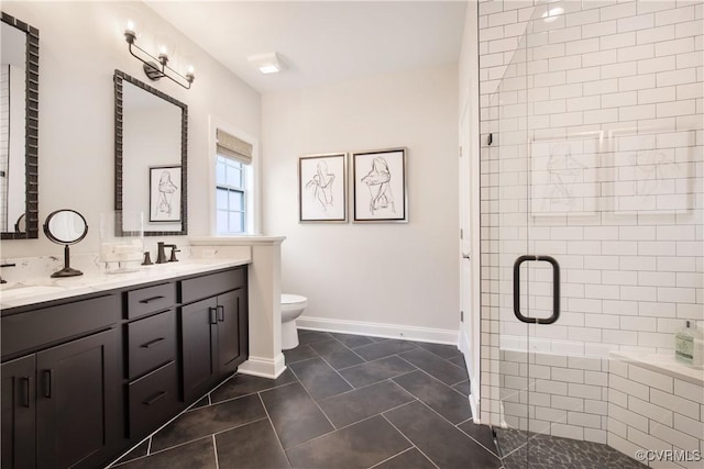 bathroom with vanity, tile patterned flooring, toilet, and walk in shower