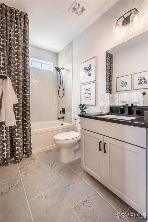 full bathroom featuring tiled shower / bath, vanity, and toilet