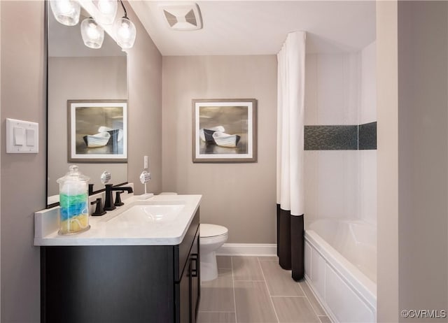 bathroom with vanity, tile patterned flooring, a bathtub, and toilet