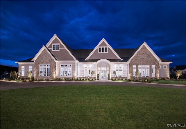 view of front facade with a yard and french doors