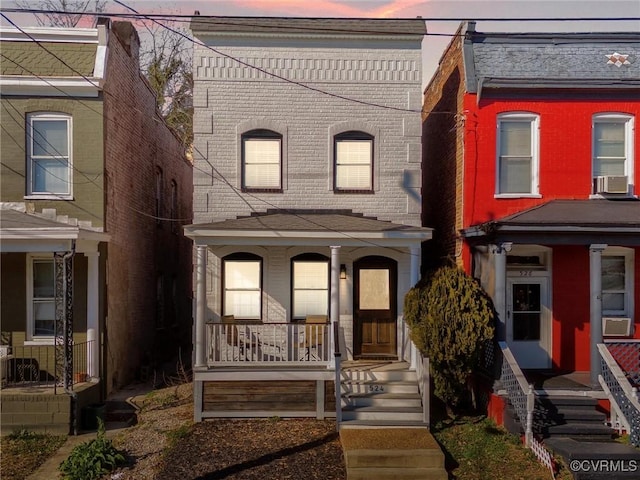 multi unit property featuring cooling unit and a porch