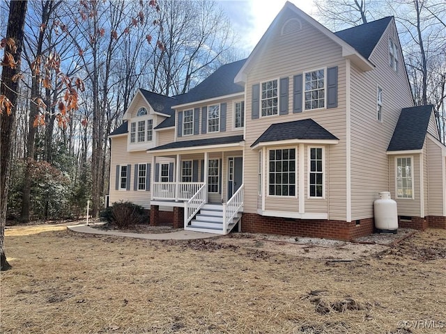 view of front of property with a front yard and covered porch