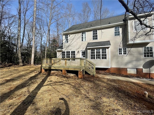 back of house with a wooden deck