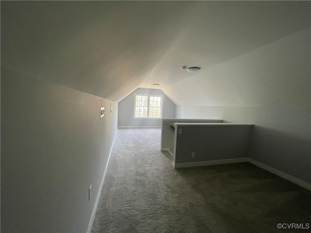 bonus room featuring lofted ceiling and carpet flooring