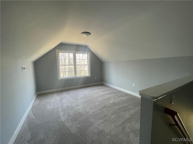 additional living space with vaulted ceiling and carpet floors