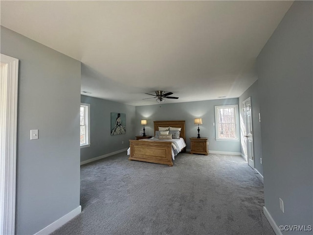 unfurnished bedroom with ceiling fan, multiple windows, and carpet