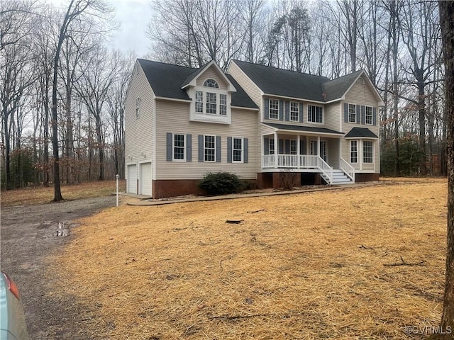 view of front property featuring a porch and a garage