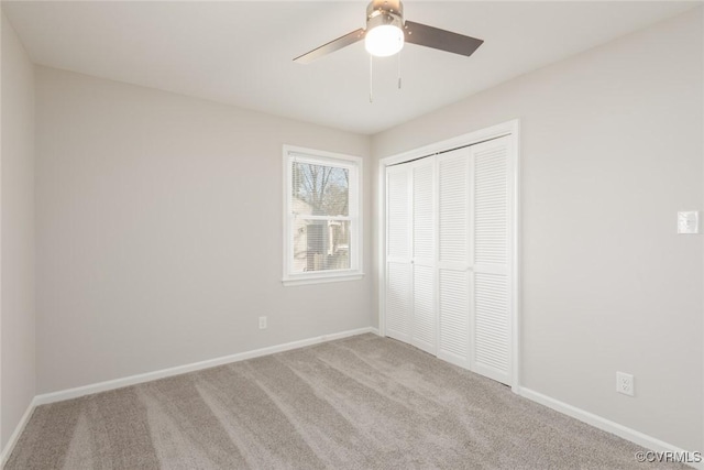 unfurnished bedroom with light colored carpet, ceiling fan, and a closet