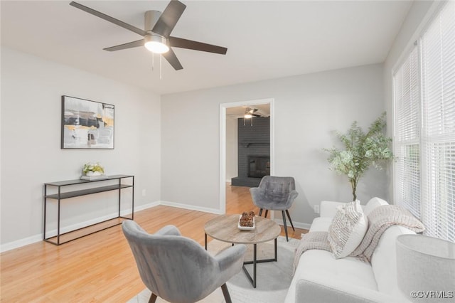 living room featuring hardwood / wood-style floors and ceiling fan