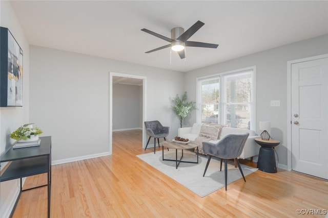 sitting room featuring hardwood / wood-style floors and ceiling fan