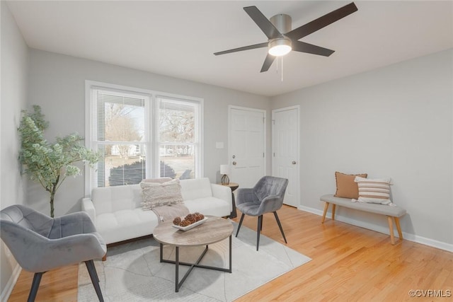 living room featuring hardwood / wood-style floors and ceiling fan