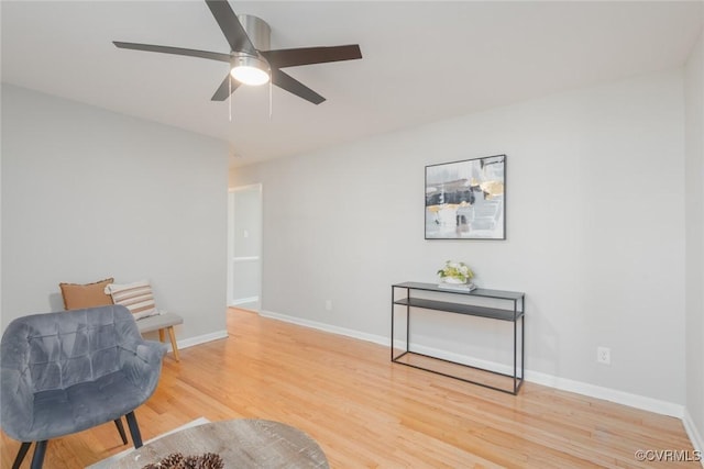 sitting room featuring hardwood / wood-style flooring and ceiling fan