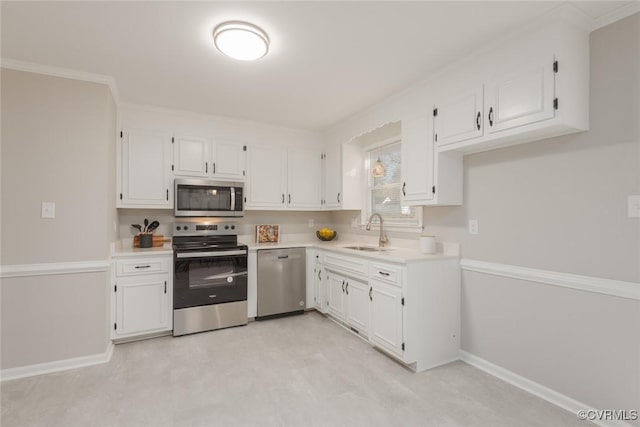 kitchen with crown molding, appliances with stainless steel finishes, sink, and white cabinets