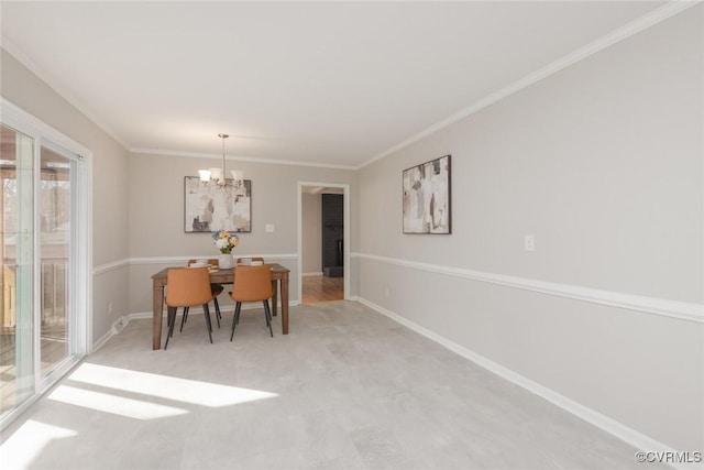 dining space with crown molding and a notable chandelier