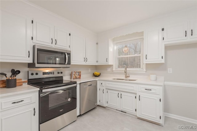 kitchen featuring stainless steel appliances, sink, and white cabinets